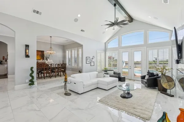 a living room with furniture and a chandelier