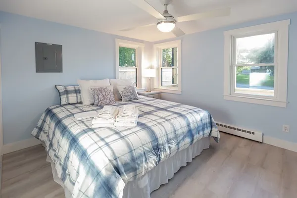 a large bed sitting in a bedroom next to a window