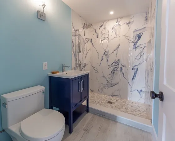 a bathroom with a toilet sink and shower