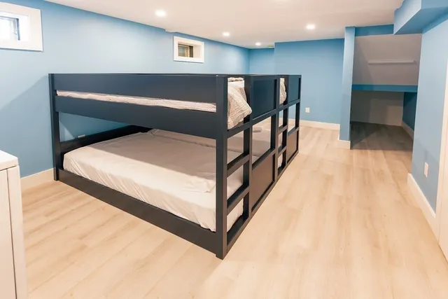 a bedroom with a bed and a view of kitchen