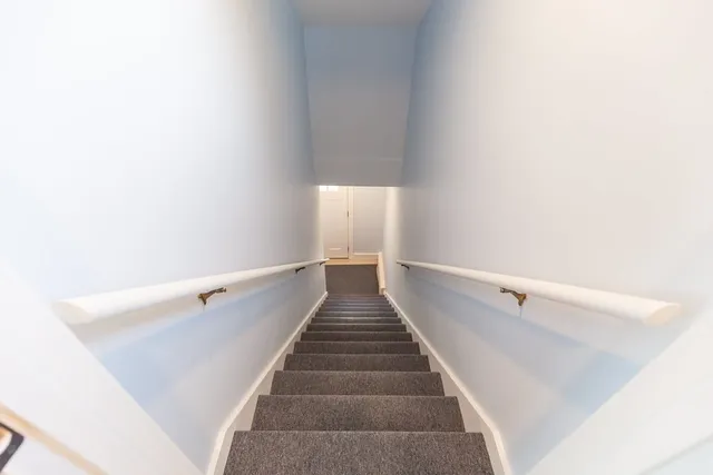 a kitchen with stainless steel appliances a stove a sink and white cabinets