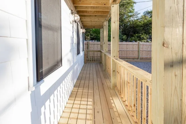 a view of balcony with wooden floor