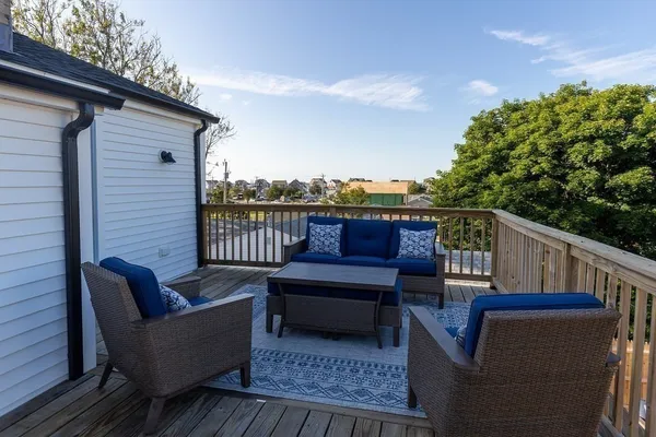 a view of sitting area on roof deck with furniture