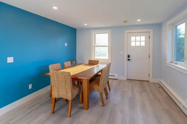 a view of a dining room with furniture and wooden floor