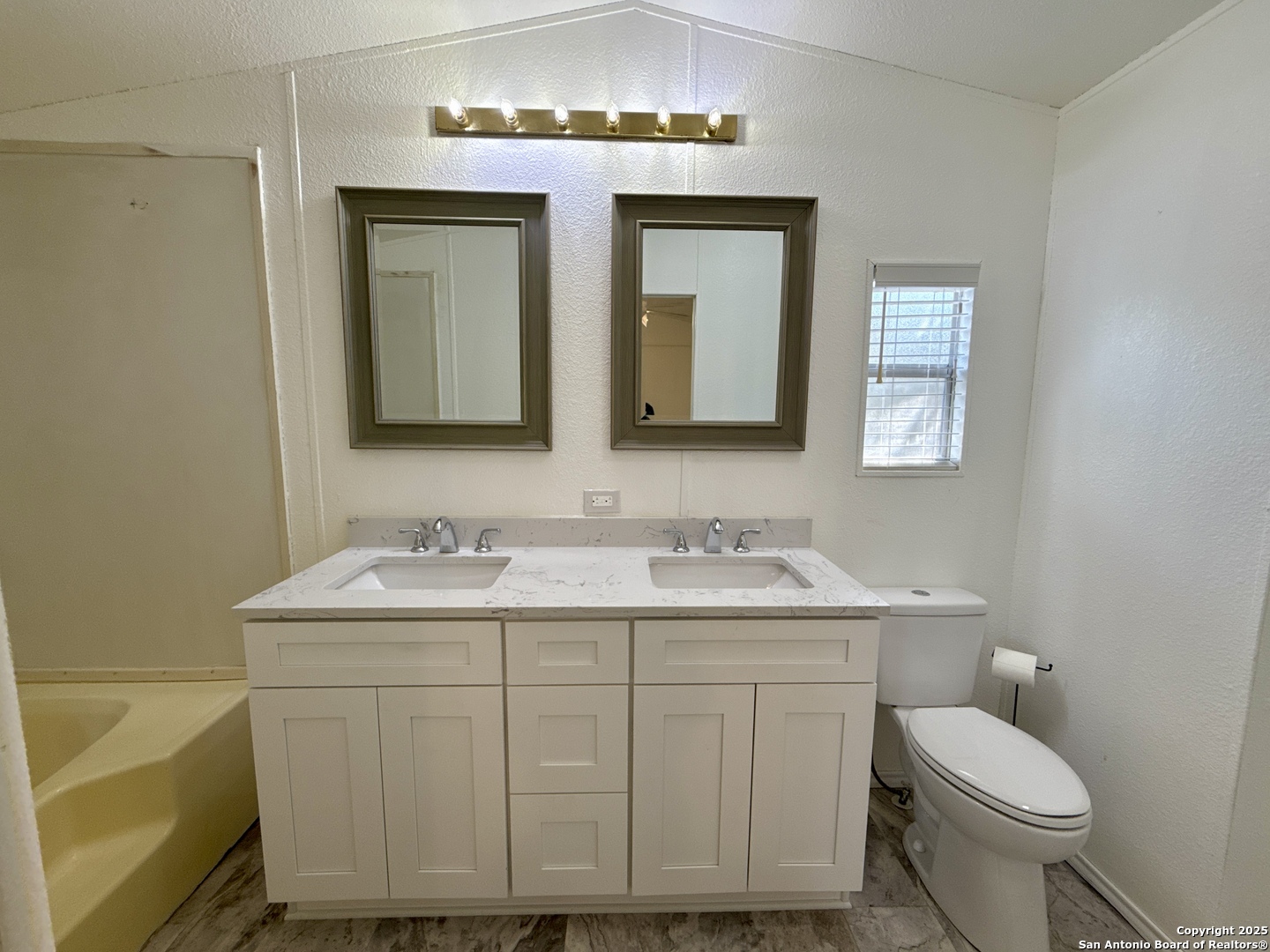 300 Pecos Road Bandera, TX 78003 - Photo 14 of 44 a bathroom with a toilet sink and mirror