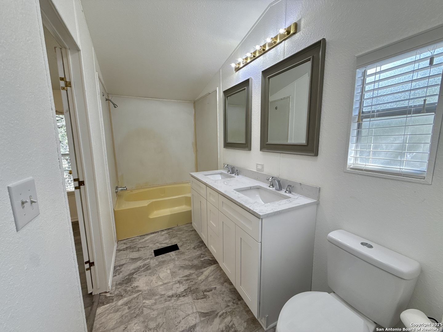 300 Pecos Road Bandera, TX 78003 - Photo 15 of 44 a bathroom with a granite countertop sink toilet and shower