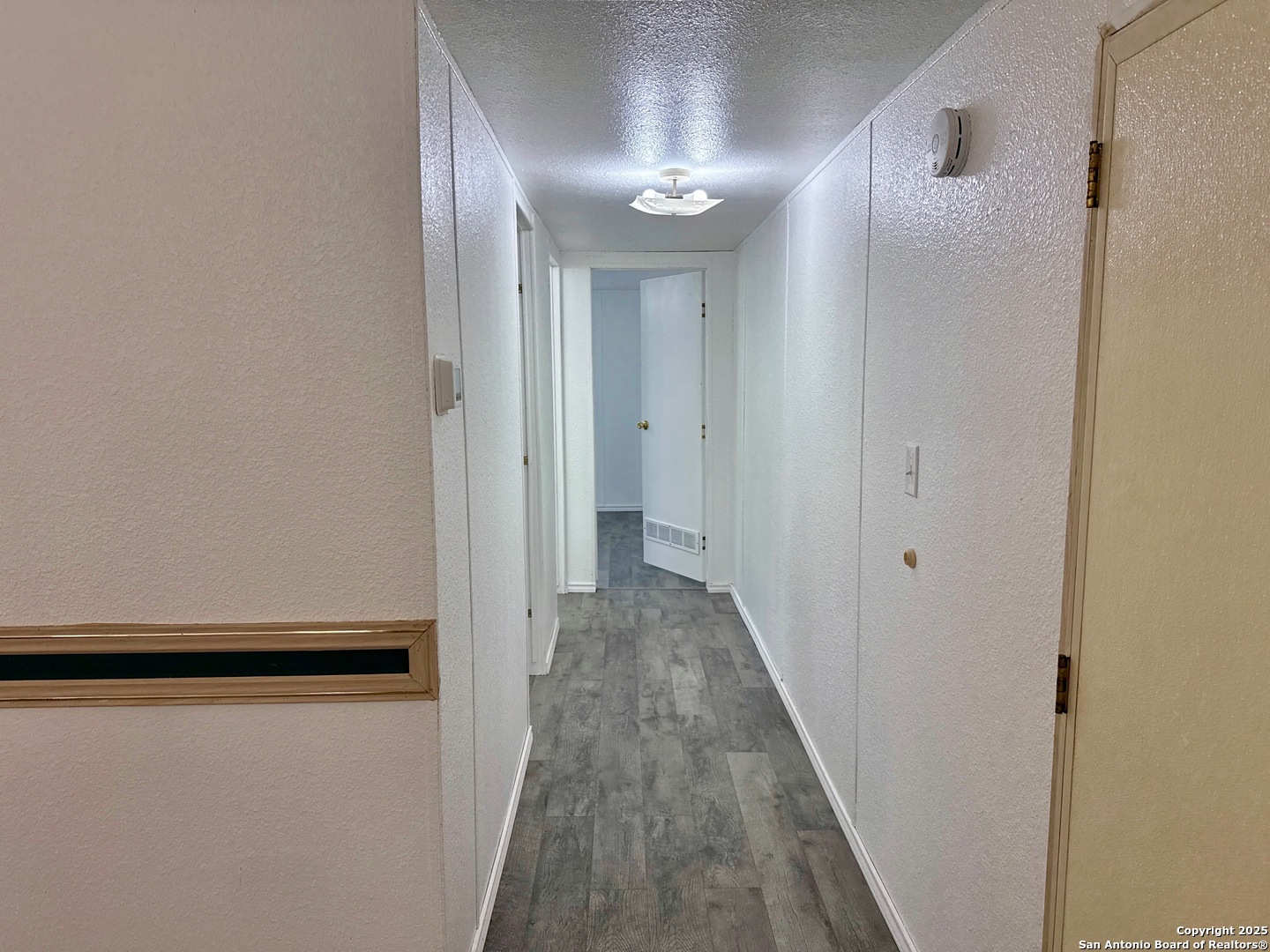 300 Pecos Road Bandera, TX 78003 - Photo 16 of 44 a view of a hallway with wooden floor