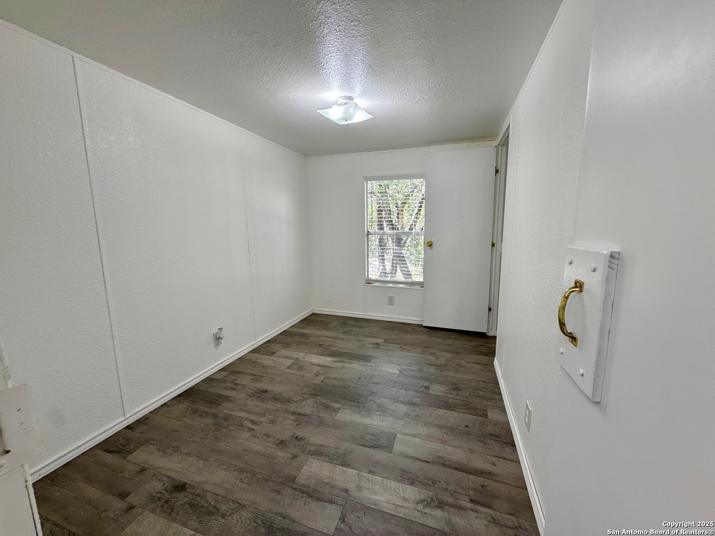 300 Pecos Road Bandera, TX 78003 - Photo 17 of 44 a view of a hardwood floor and a window in a room