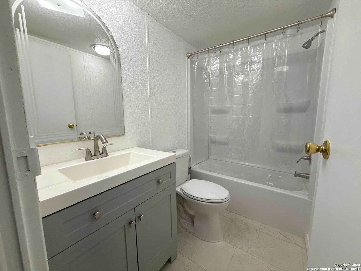 300 Pecos Road Bandera, TX 78003 - Photo 21 of 44 a bathroom with a sink mirror toilet and bathtub