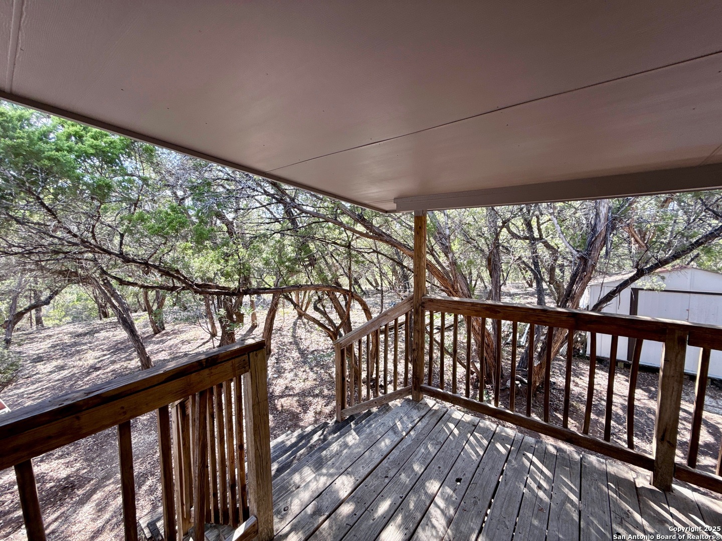 300 Pecos Road Bandera, TX 78003 - Photo 24 of 44 a balcony with wooden floor and outdoor space