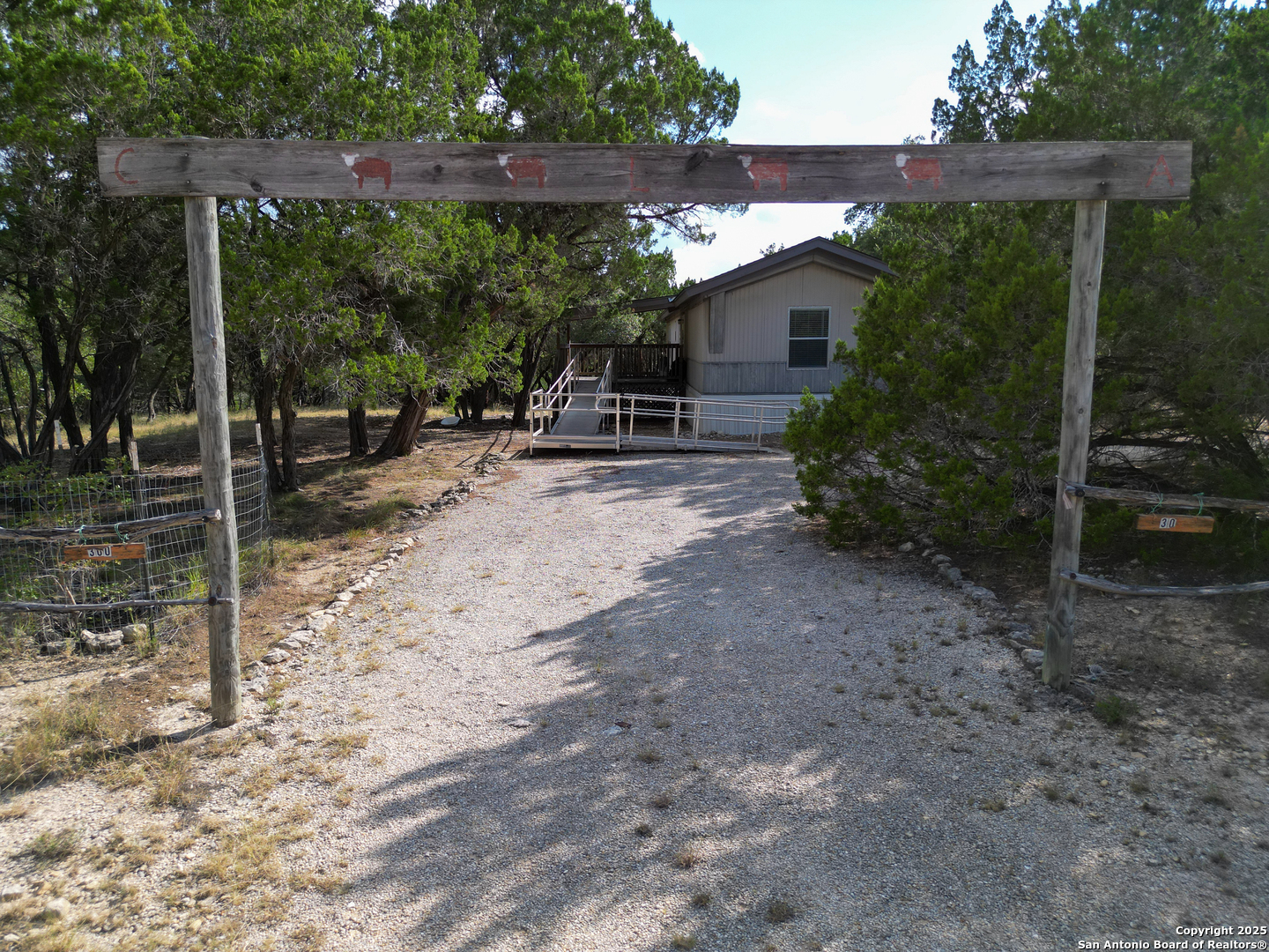 300 Pecos Road Bandera, TX 78003 - Photo 4 of 44 a view of a house with backyard and sitting area