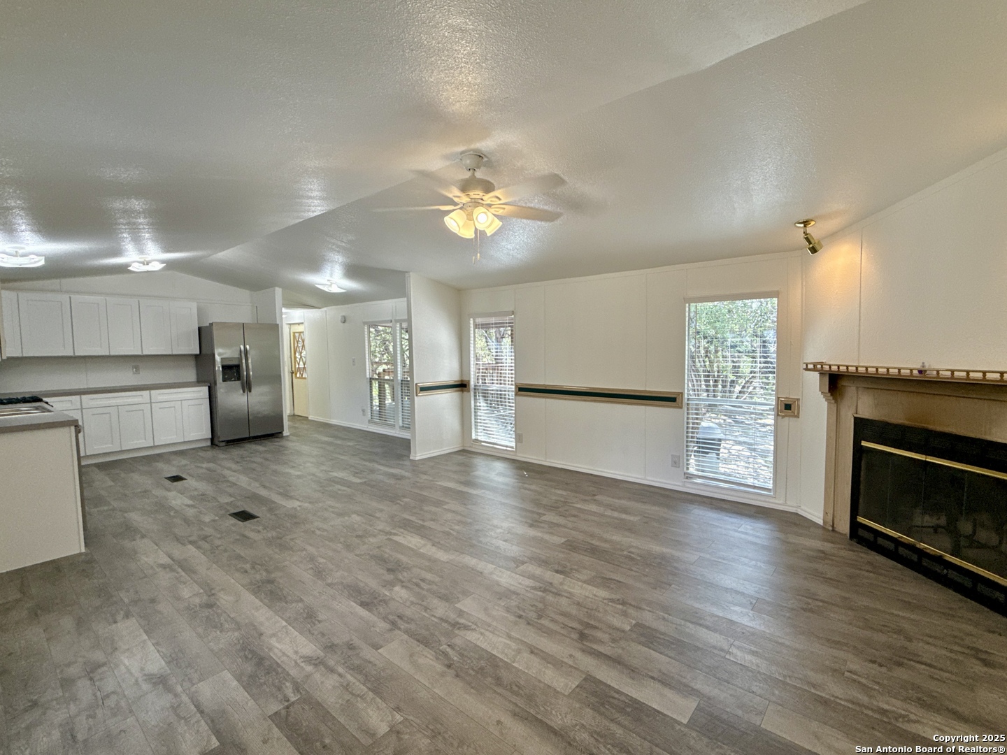 300 Pecos Road Bandera, TX 78003 - Photo 5 of 44 a view of a kitchen with a stove cabinets and wooden floor