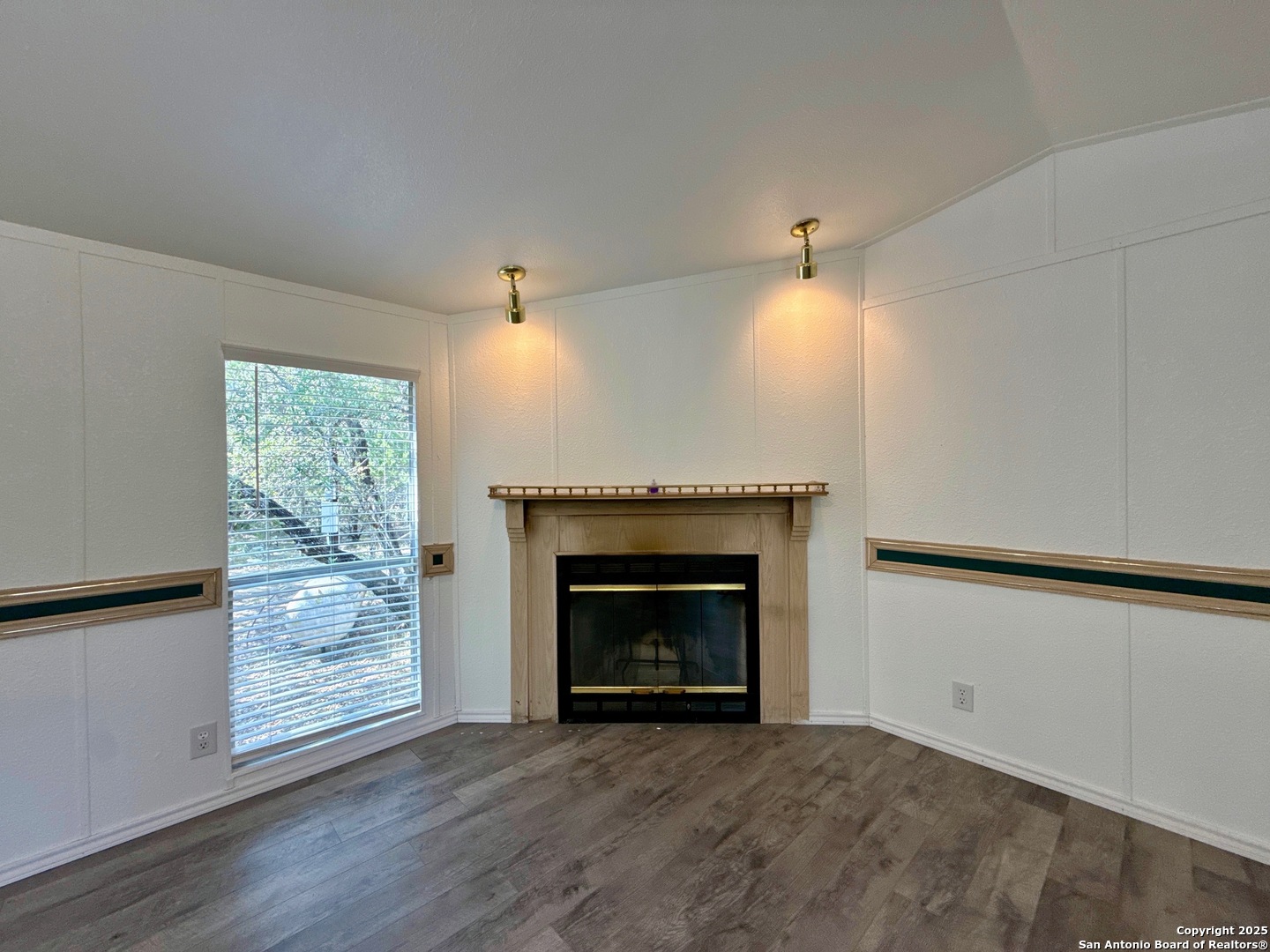 300 Pecos Road Bandera, TX 78003 - Photo 7 of 44 wooden floor fireplace and natural light in room