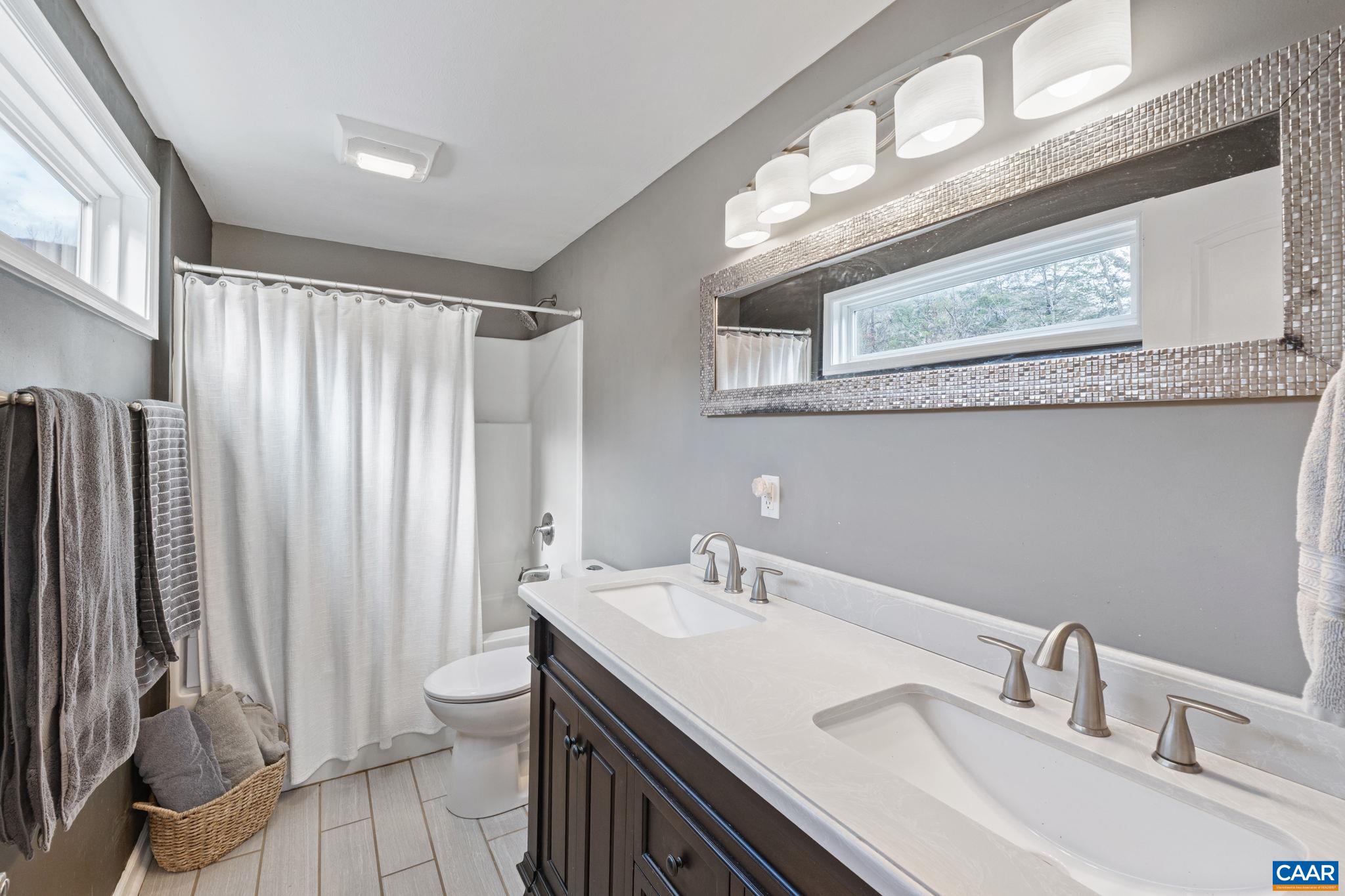 504 Newtown Road Greenwood, VA 22943 - Photo 17 of 34 a bathroom with a sink a toilet and a mirror