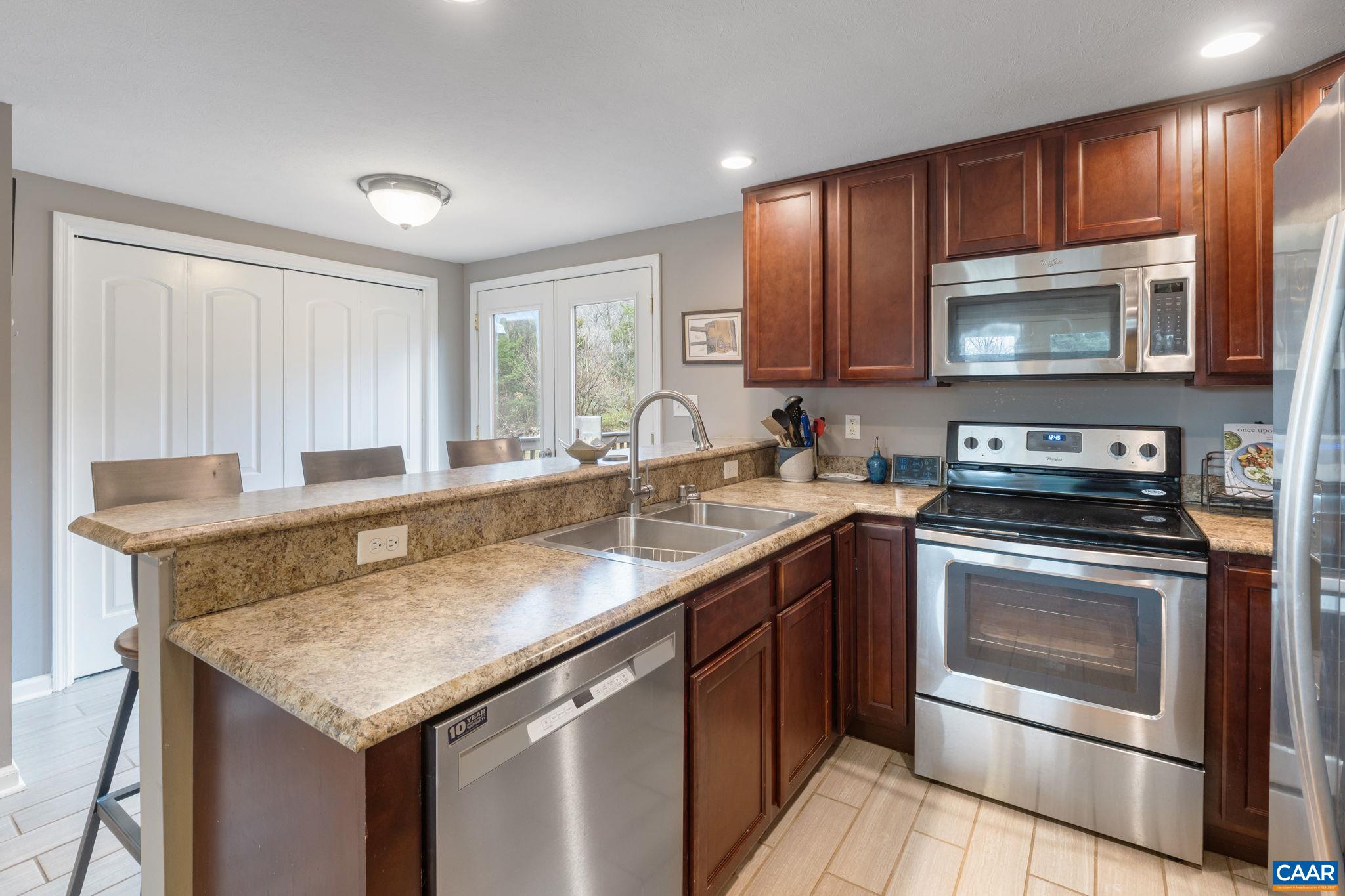 504 Newtown Road Greenwood, VA 22943 - Photo 9 of 34 a kitchen with a stove sink and microwave