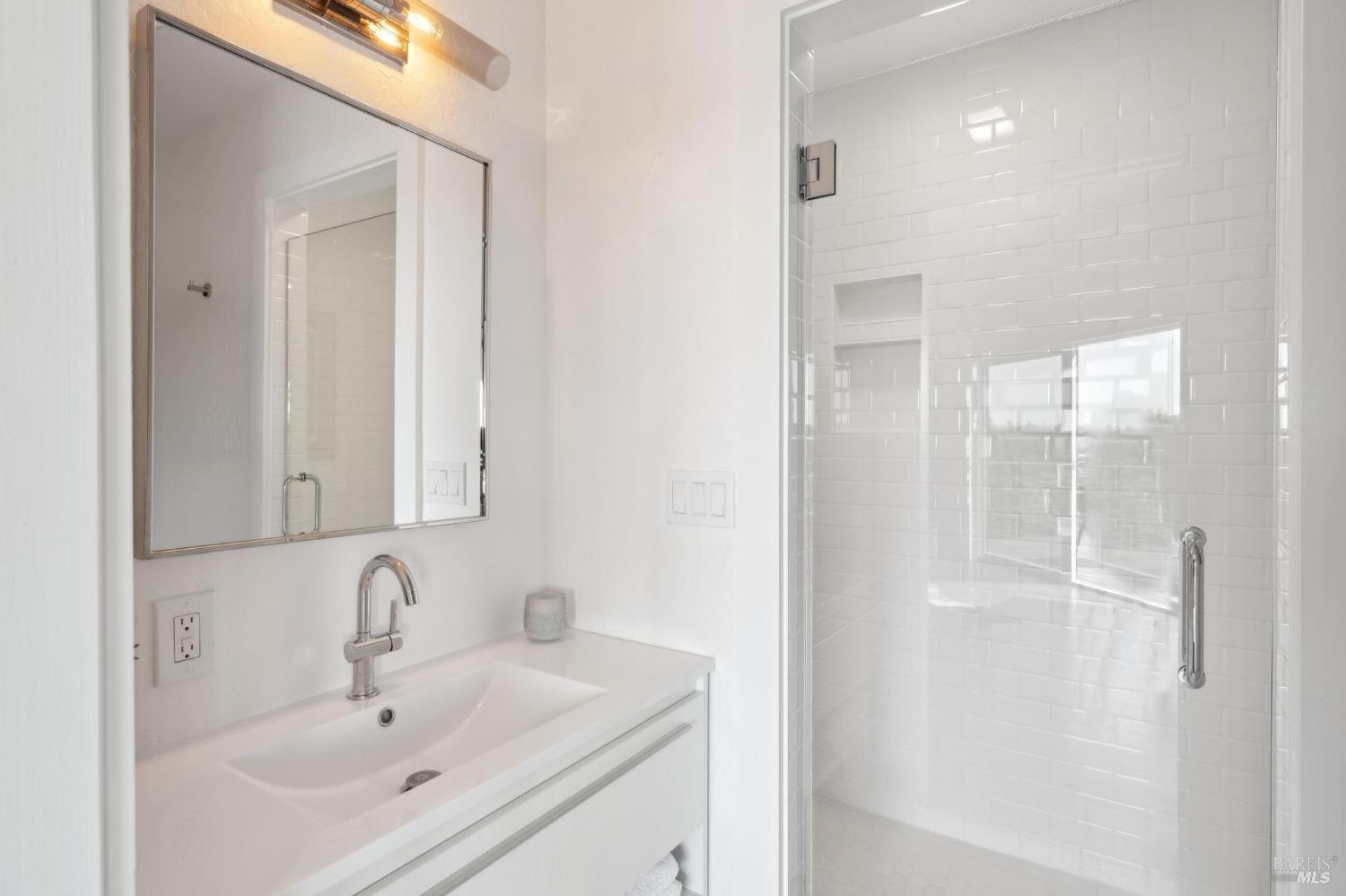 3485 Ridgeview Drive Santa Rosa, CA 95404 - Photo 29 of 63 a bathroom with a sink a mirror and shower