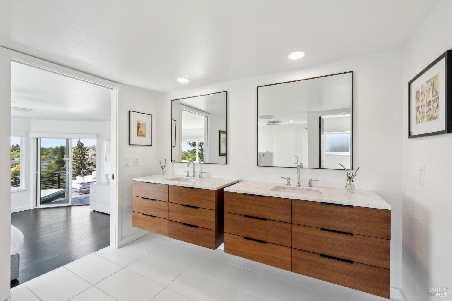 3485 Ridgeview Drive Santa Rosa, CA 95404 - Photo 34 of 63 a bathroom with a double vanity sink a large mirror and shower