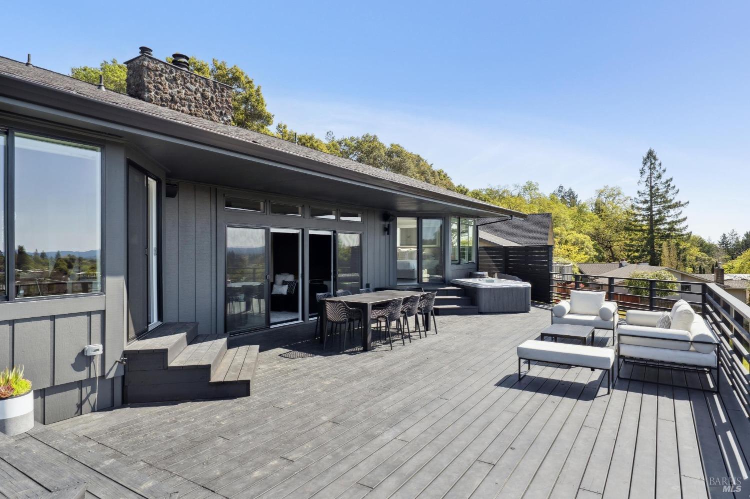 3485 Ridgeview Drive Santa Rosa, CA 95404 - Photo 46 of 63 a view of a patio with dining table and chairs with wooden floor and fence