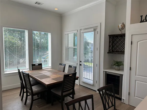 a view of a dining room with furniture and a window