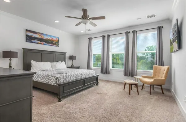 a bedroom with a bed and a large window