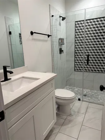 a bathroom with a sink toilet and shower