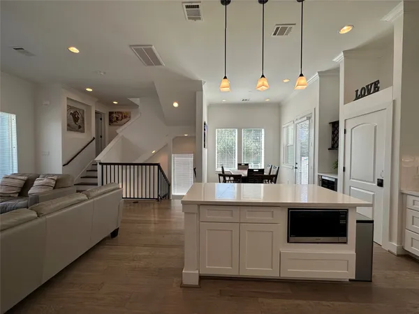 a very nice looking living room with a large window and kitchen view