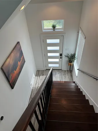 a view of entryway and hall with wooden floor
