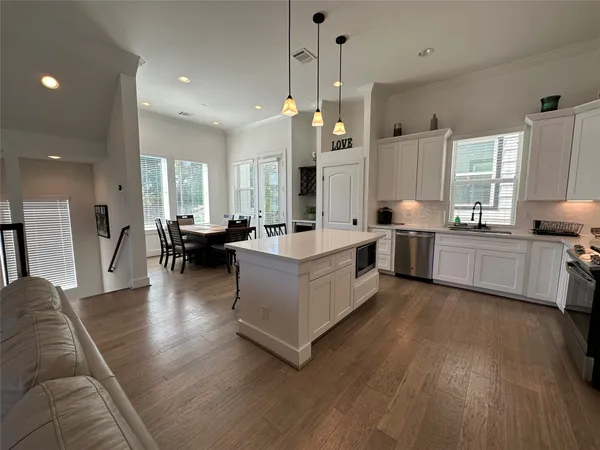 a living room with furniture window and wooden floor
