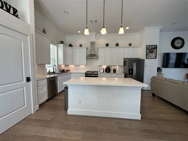 a kitchen with stainless steel appliances a stove a sink and a refrigerator