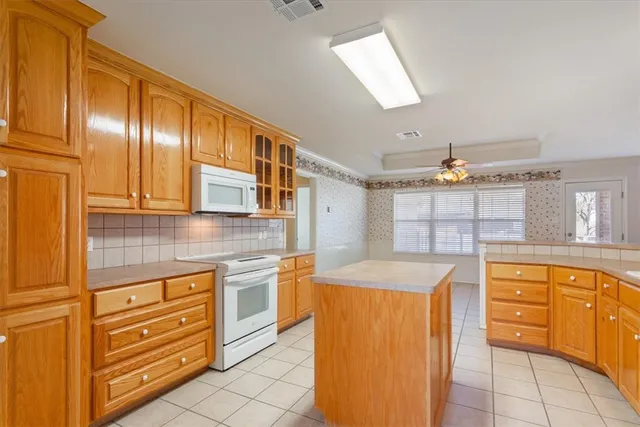 a kitchen with granite countertop cabinets and window