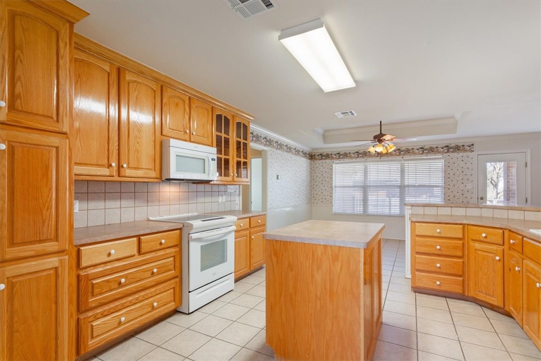 306 Baker Lane Robinson, TX 76706 - Photo 12 of 28 a kitchen with granite countertop cabinets and window