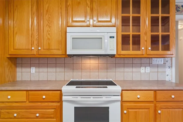 a stove top oven sitting inside of a kitchen