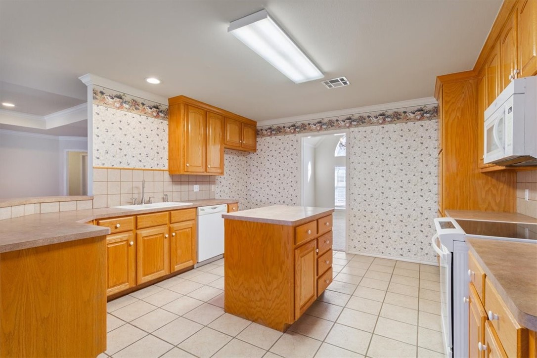 306 Baker Lane Robinson, TX 76706 - Photo 14 of 28 a kitchen with granite countertop a sink and a stove top oven