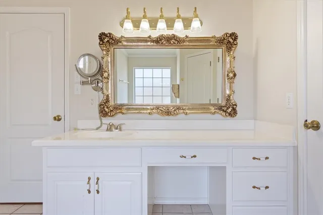 a bathroom with a sink vanity and a mirror