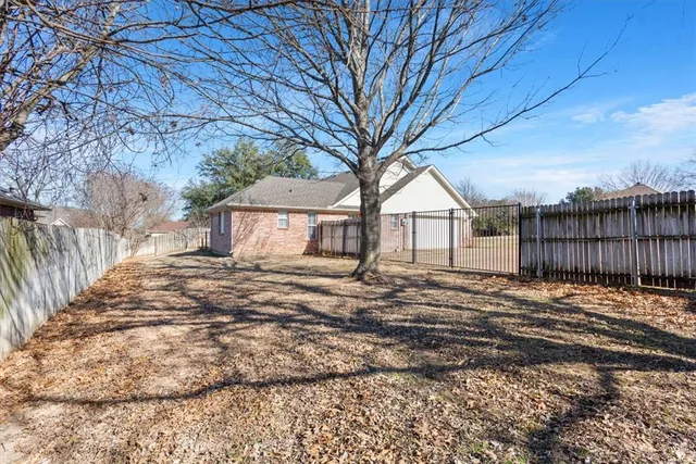 a white house that has a tree in front of it