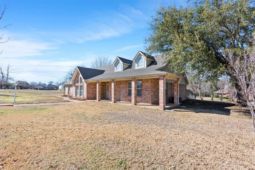 306 Baker Lane Robinson, TX 76706 - Photo 3 of 28 a front view of a house with a yard and ocean view