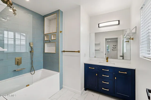 a bathroom with a tub toilet and shower