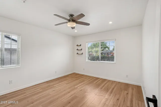 a kitchen with granite countertop stainless steel appliances a refrigerator cabinets and wooden floor