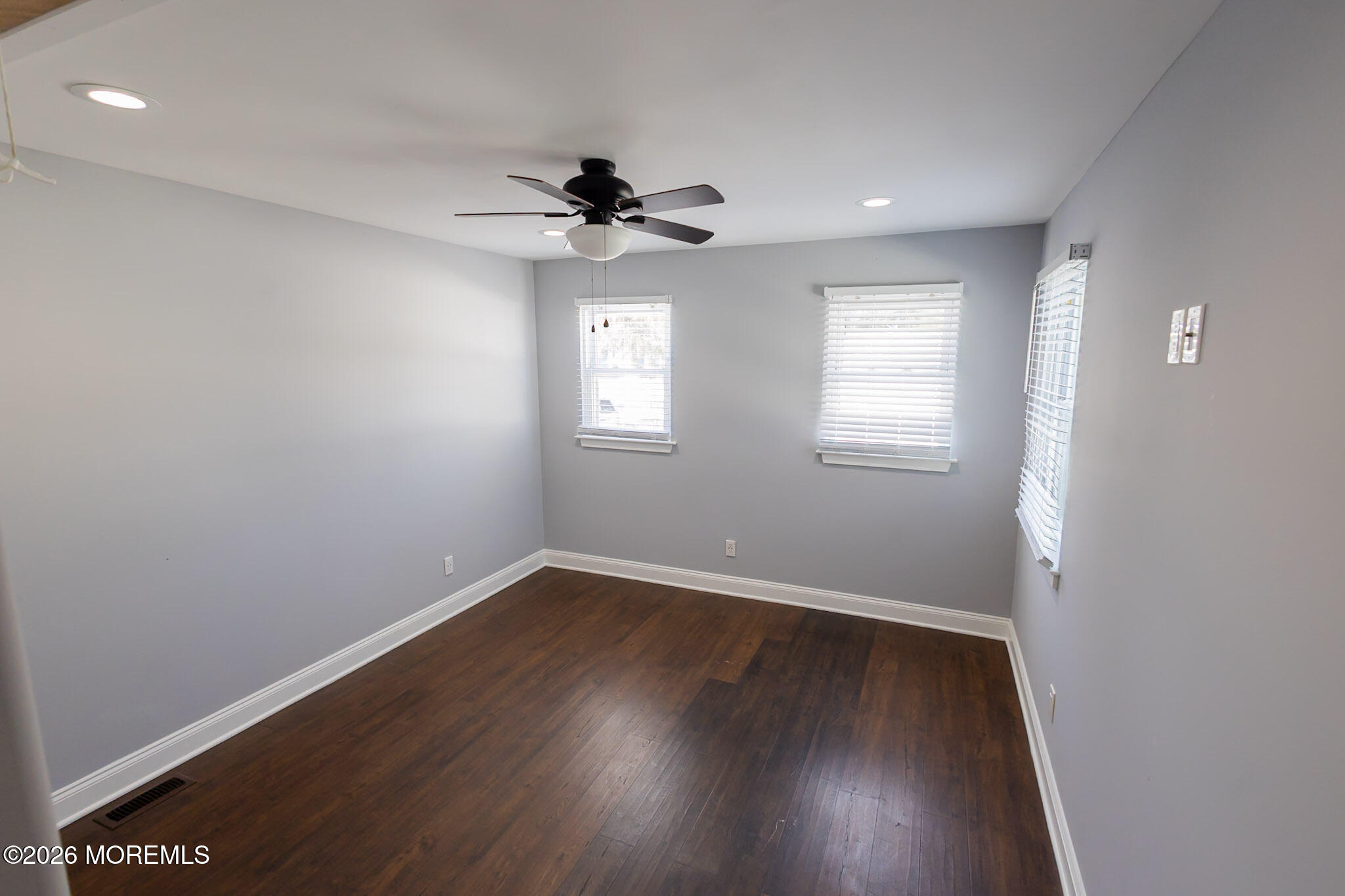20 Grace Lane Howell, NJ 07731 - Photo 9 of 20 an empty room with wooden floor fan and windows