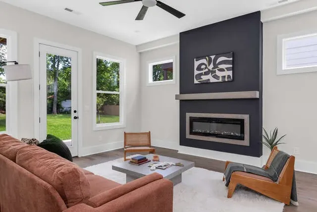 a living room with furniture and a fireplace