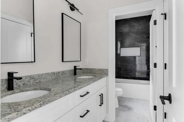 a bathroom with sink bathtub and mirror