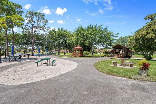 a swimming pool with outdoor seating and trees