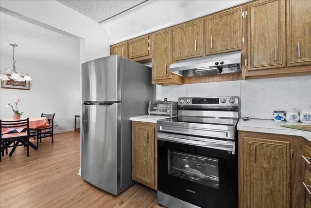 a kitchen with cabinets and steel stainless steel appliances