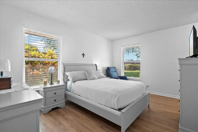 a bedroom with a large bed and a window