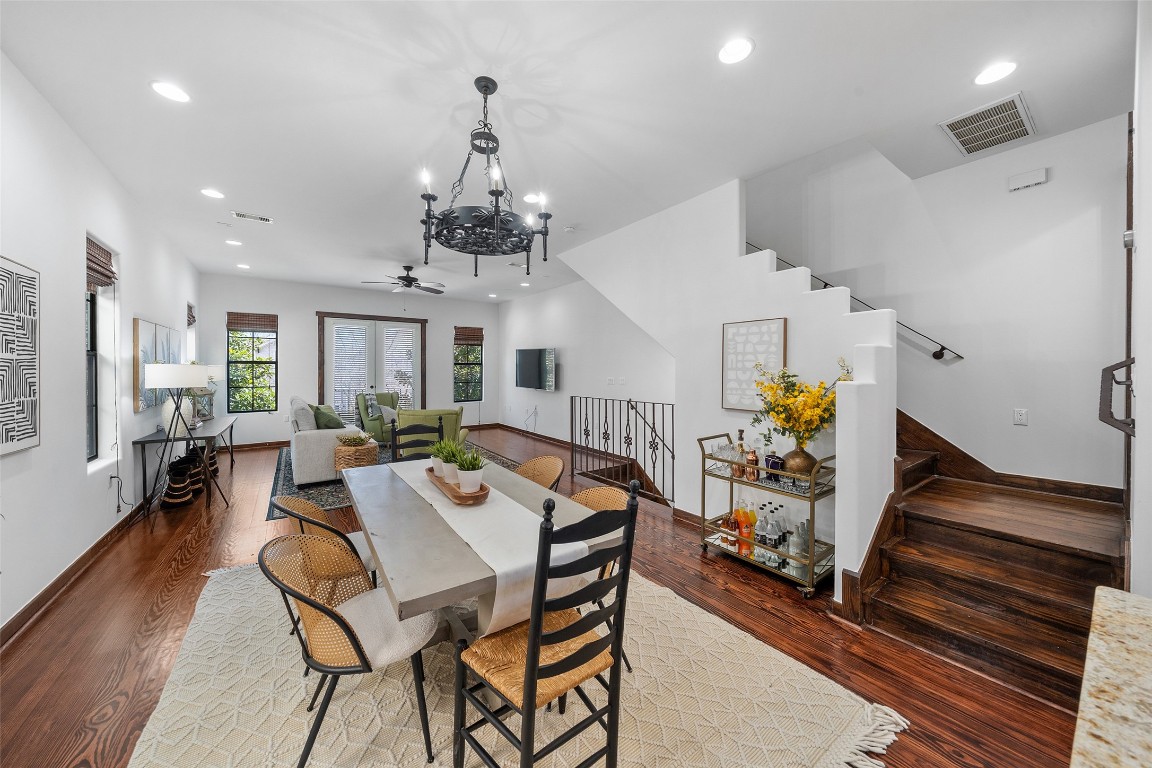 2601 Bevis Street, Unit E Houston, TX 77008 - Photo 16 of 47 Open dining area overlooking the spacious
second-floor living space, highlighted by rich
wood floors and a statement chandelier. The
staircase leads to the third-floor private
bedroom level, creating a thoughtful separation
between living and sleeping areas.