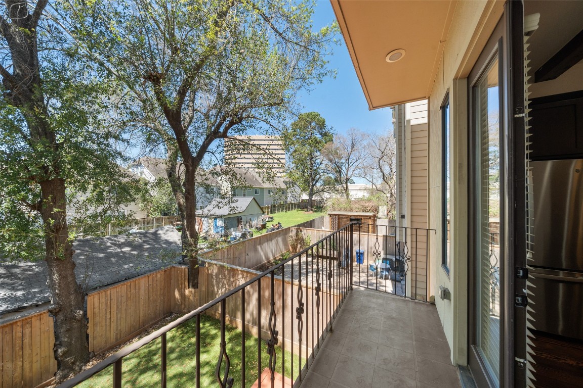 2601 Bevis Street, Unit E Houston, TX 77008 - Photo 20 of 47 Enjoy outdoor living on the private second-floor
balcony overlooking the backyard and mature trees. A
perfect spot for morning coffee or relaxing evenings
just off the main living area.