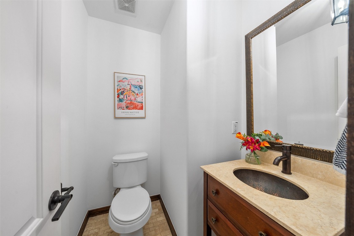 2601 Bevis Street, Unit E Houston, TX 77008 - Photo 21 of 47 Convenient second-floor powder bath featuring a
granite countertop vanity, stylish sink, and warm
wood cabinetry. Ideally located off the main living
and dining areas for guests.