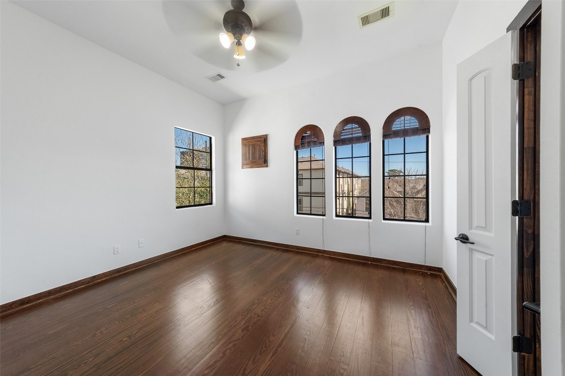 2601 Bevis Street, Unit E Houston, TX 77008 - Photo 30 of 47 Light-filled third-floor secondary bedroom featuring
rich wood floors and a charming row of arched
windows that bring in abundant natural light. This
spacious room offers flexibility for guests, family, or
a private office.