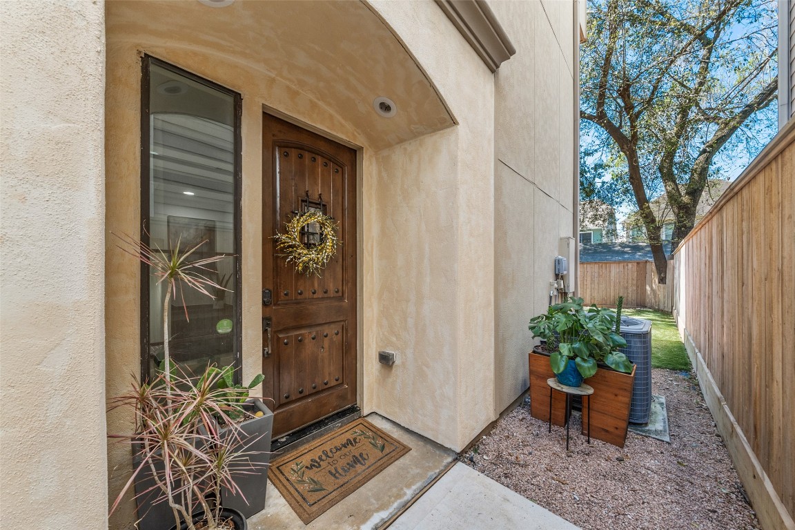 2601 Bevis Street, Unit E Houston, TX 77008 - Photo 3 of 47 Inviting covered entry featuring an arched stucco
alcove and solid wood front door that adds warmth and
character. A welcoming approach that sets the tone for
the home’s thoughtful design and Mediterranean-
inspired style.