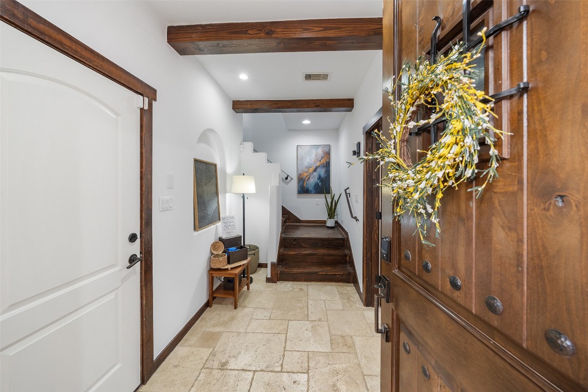 2601 Bevis Street, Unit E Houston, TX 77008 - Photo 4 of 47 Step inside to a welcoming foyer featuring natural stone
flooring, rich wood trim, and decorative ceiling beams
that add warmth and architectural character. This inviting
entry sets the tone for the home’s thoughtfully designed
interiors.